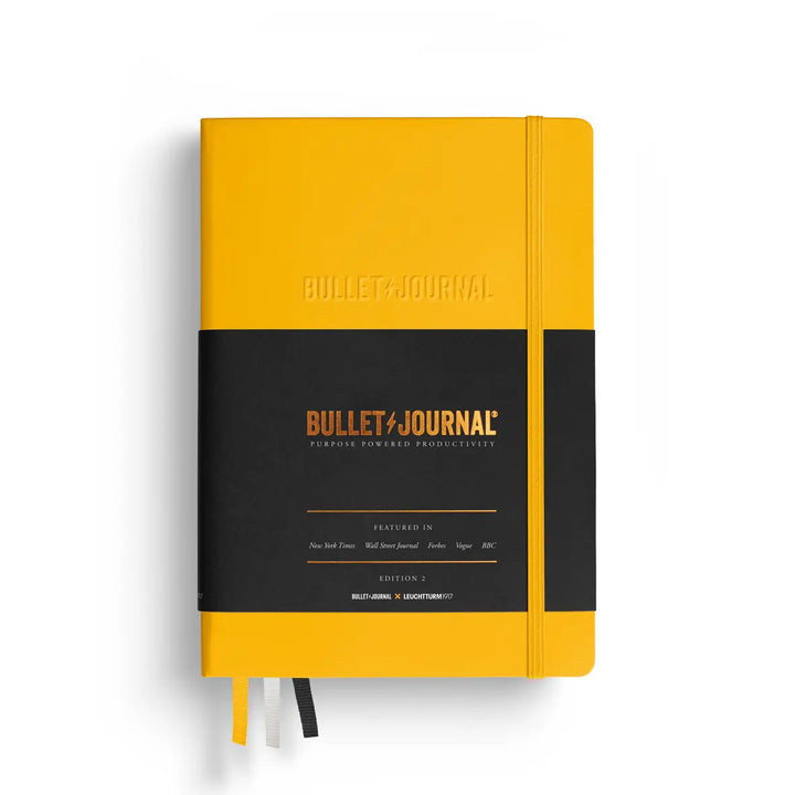 Yellow Bullet Journal notebook with branding on a white background