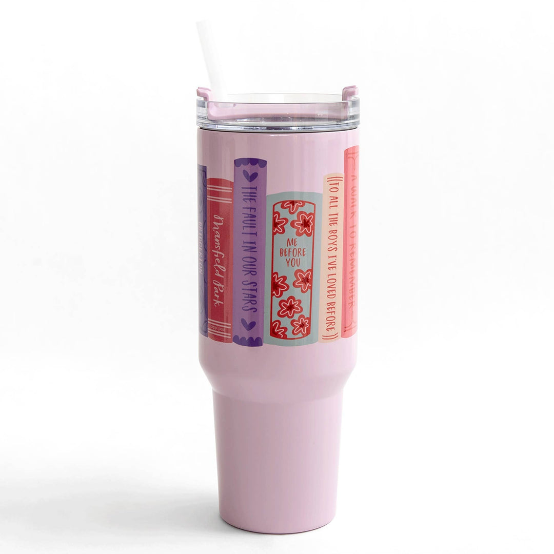 Pink tumbler with book-themed stickers on a white background