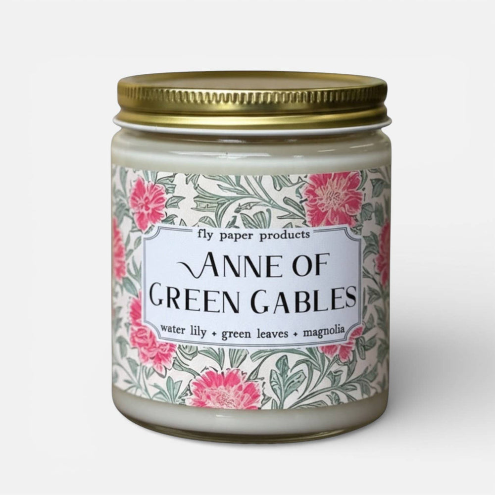 Candle jar with floral label featuring 'Anne of Green Gables' text on a white background