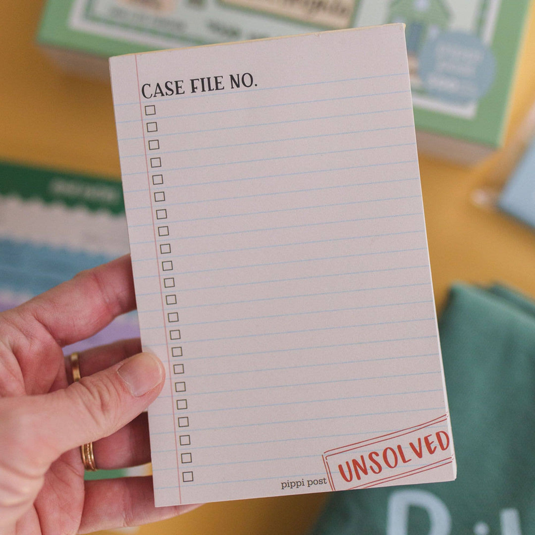 Hand holding a notepad with &