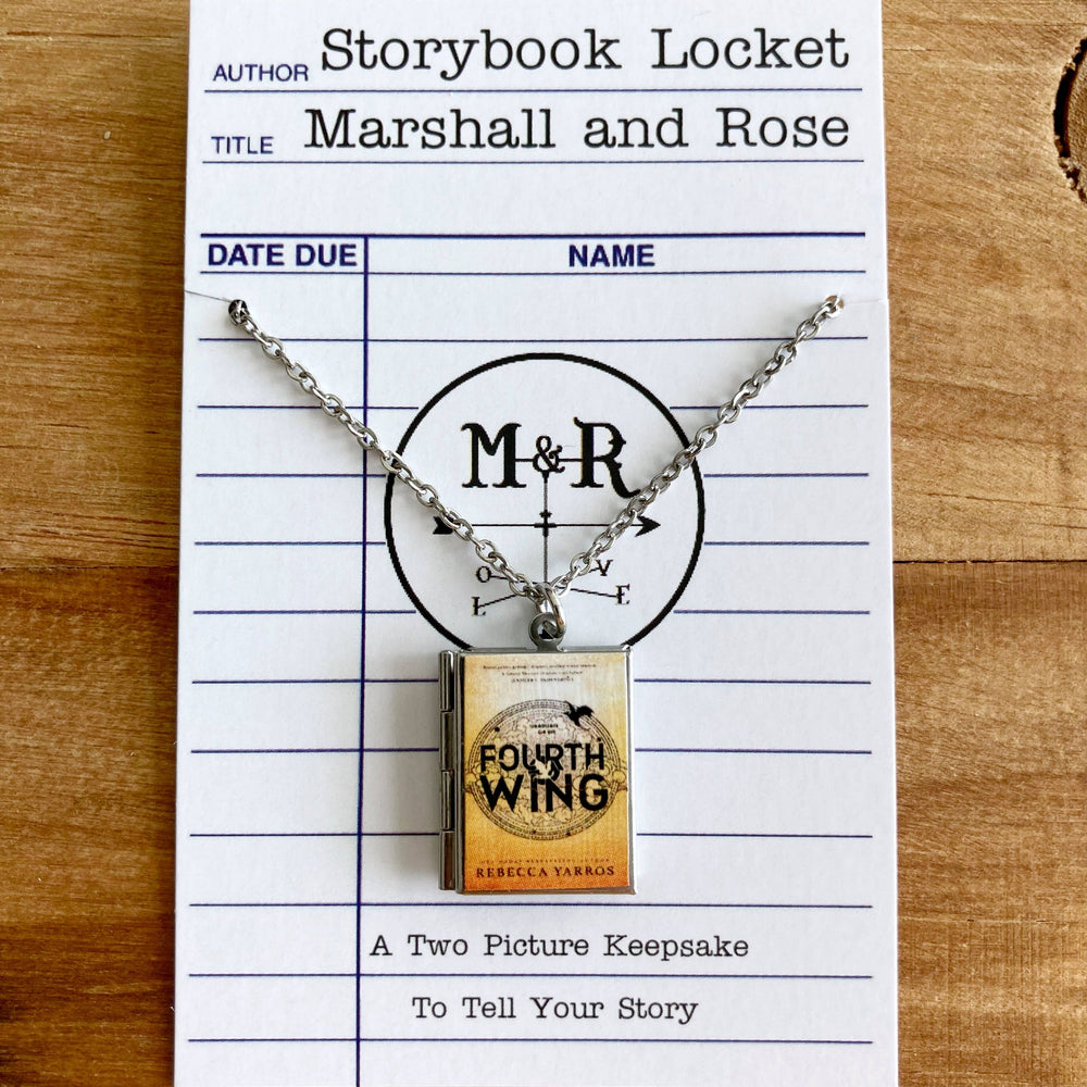 Necklace with book-shaped pendant on a library card-style card with 'M' and 'R' initials.