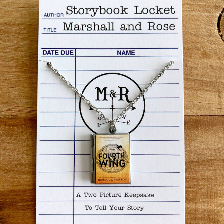 Necklace with book-shaped pendant on a library card-style card with &