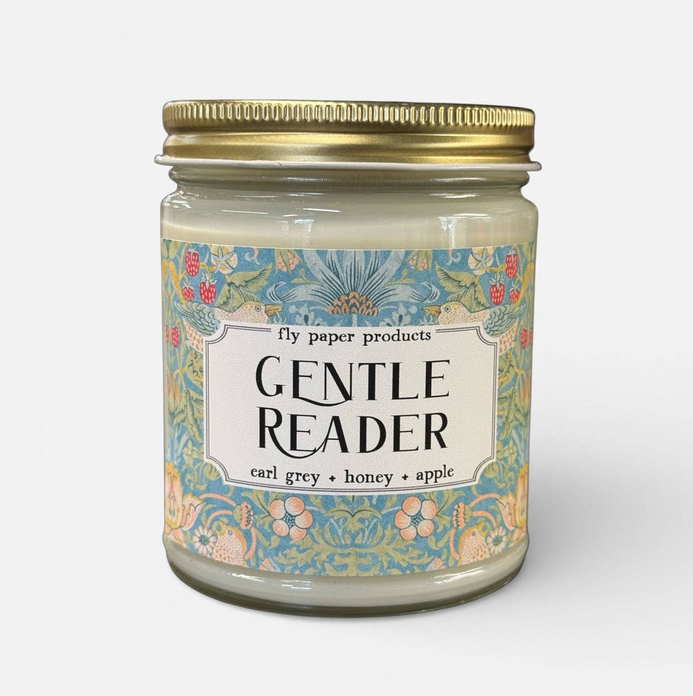 Candle jar labeled 'Gentle Reader' with decorative label on a white background