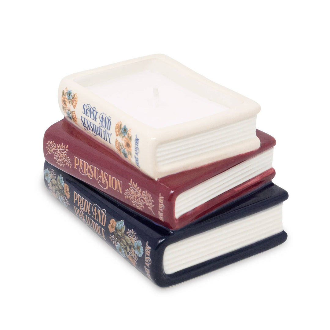 Angled view of Jane Austen bookstack candle showing white wax, a single wick, floral book spines, and sculpted page edges.