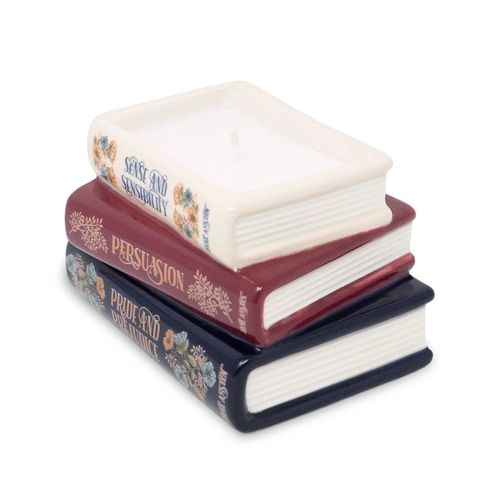 Angled view of Jane Austen bookstack candle showing white wax, a single wick, floral book spines, and sculpted page edges.