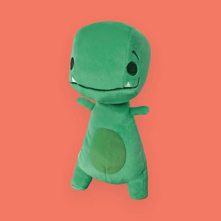 Green plush toy on a solid orange background