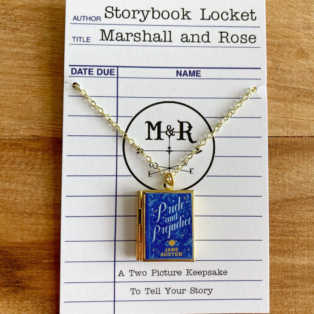 Gold necklace with 'Pride and Prejudice' book charm on a library card-style card.