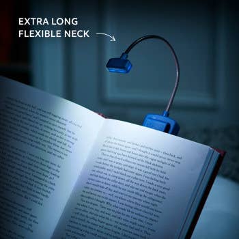 Blue book light with flexible neck on an open book, highlighting its feature.