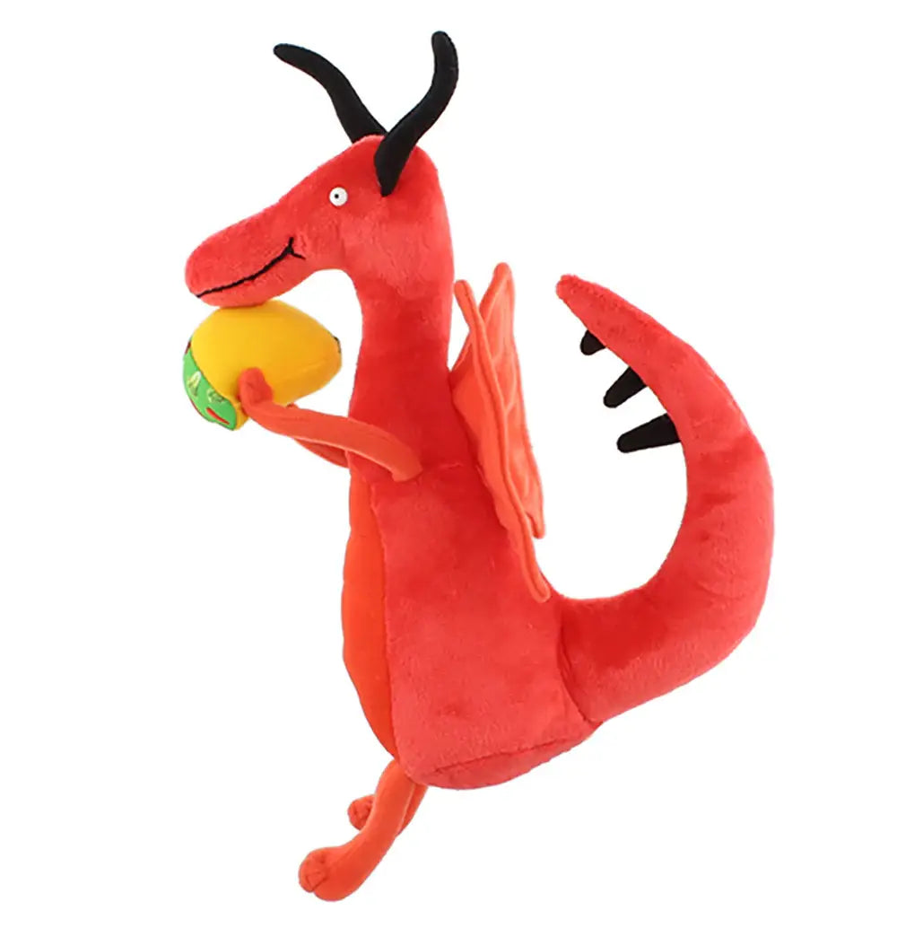 Red plush dragon toy holding a yellow ball on a white background