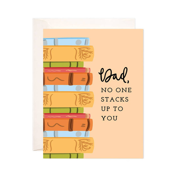 Greeting card with a stack of colorful books and text on a peach background.  Text reads &