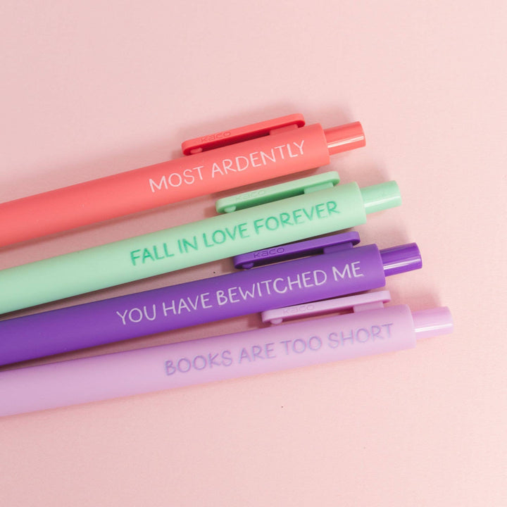 Set of colorful pens with motivational text on a pink background