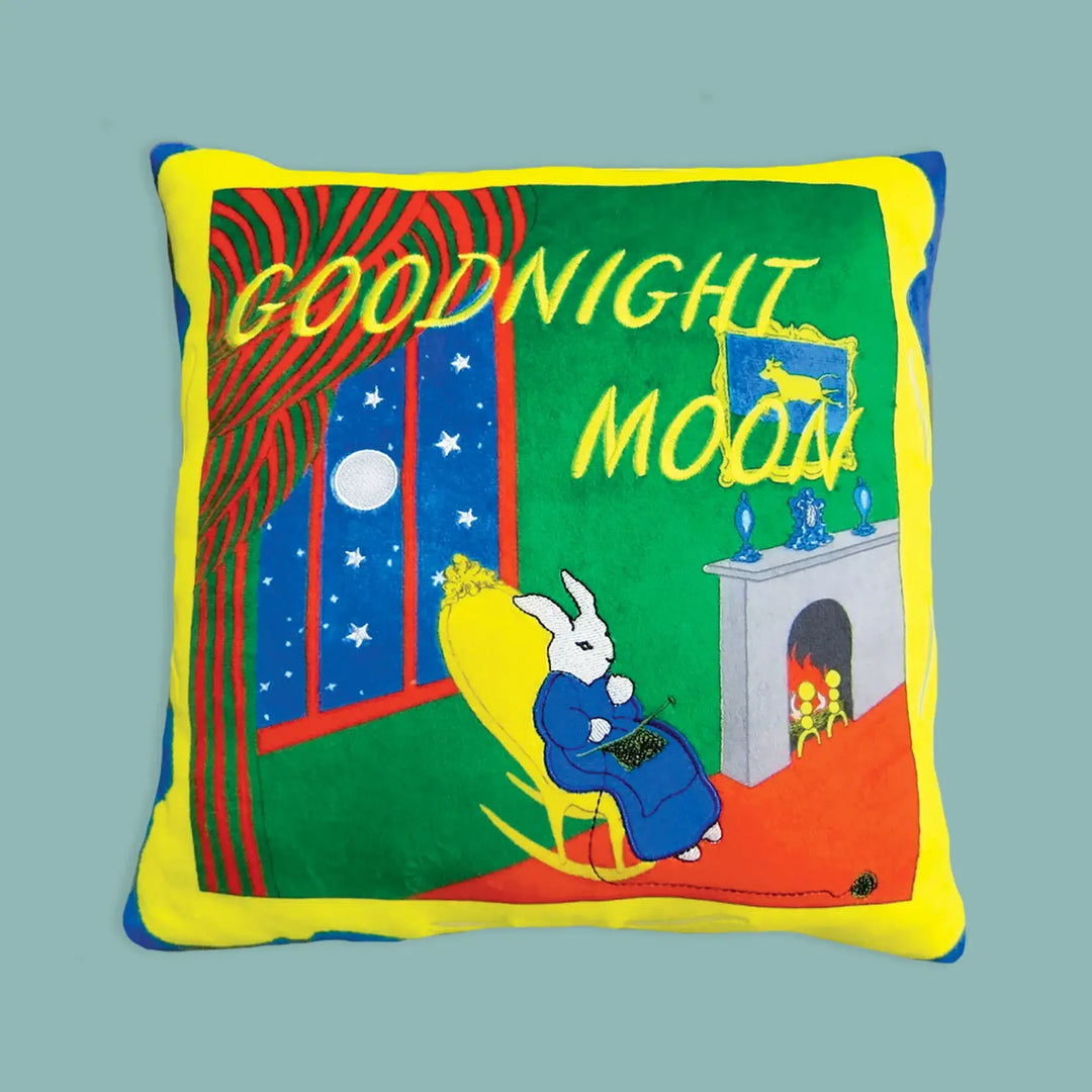 Pillow with 'Goodnight Moon' book cover design on a solid background