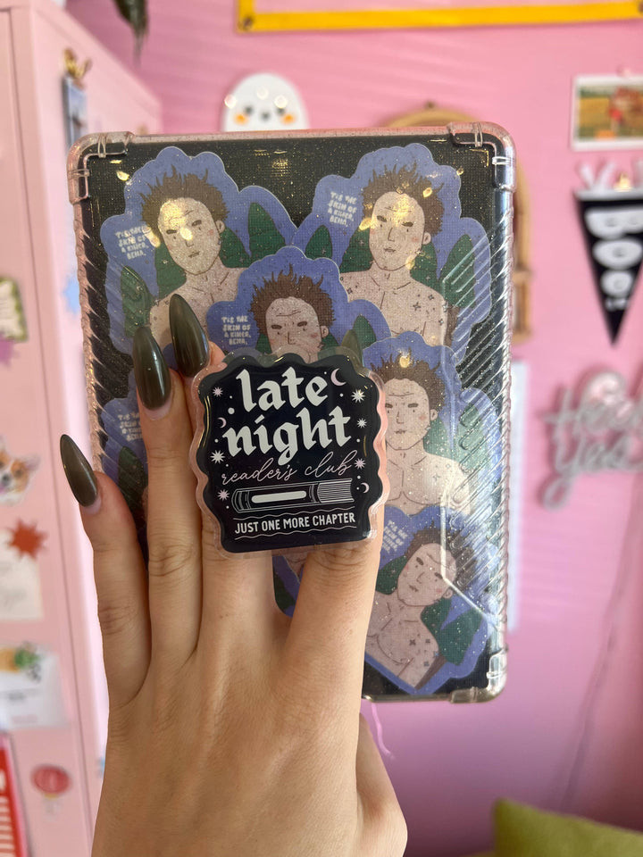 Hand holding a notebook with &