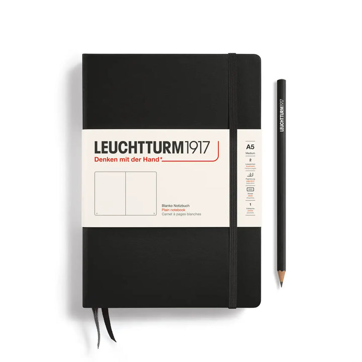 Black notebook with a pencil on a white background, featuring Leuchtturm1917 branding.