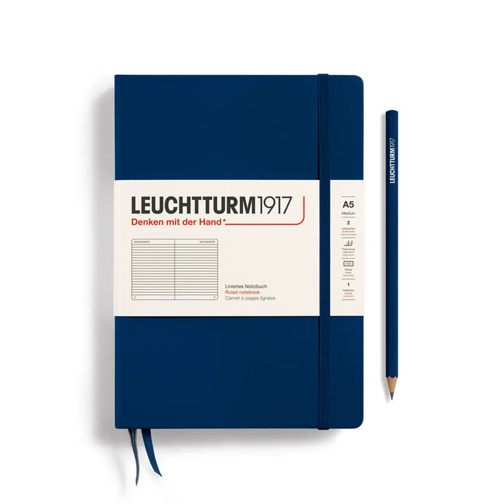 Blue notebook with Leuchtturm1917 branding and a pencil on a white background