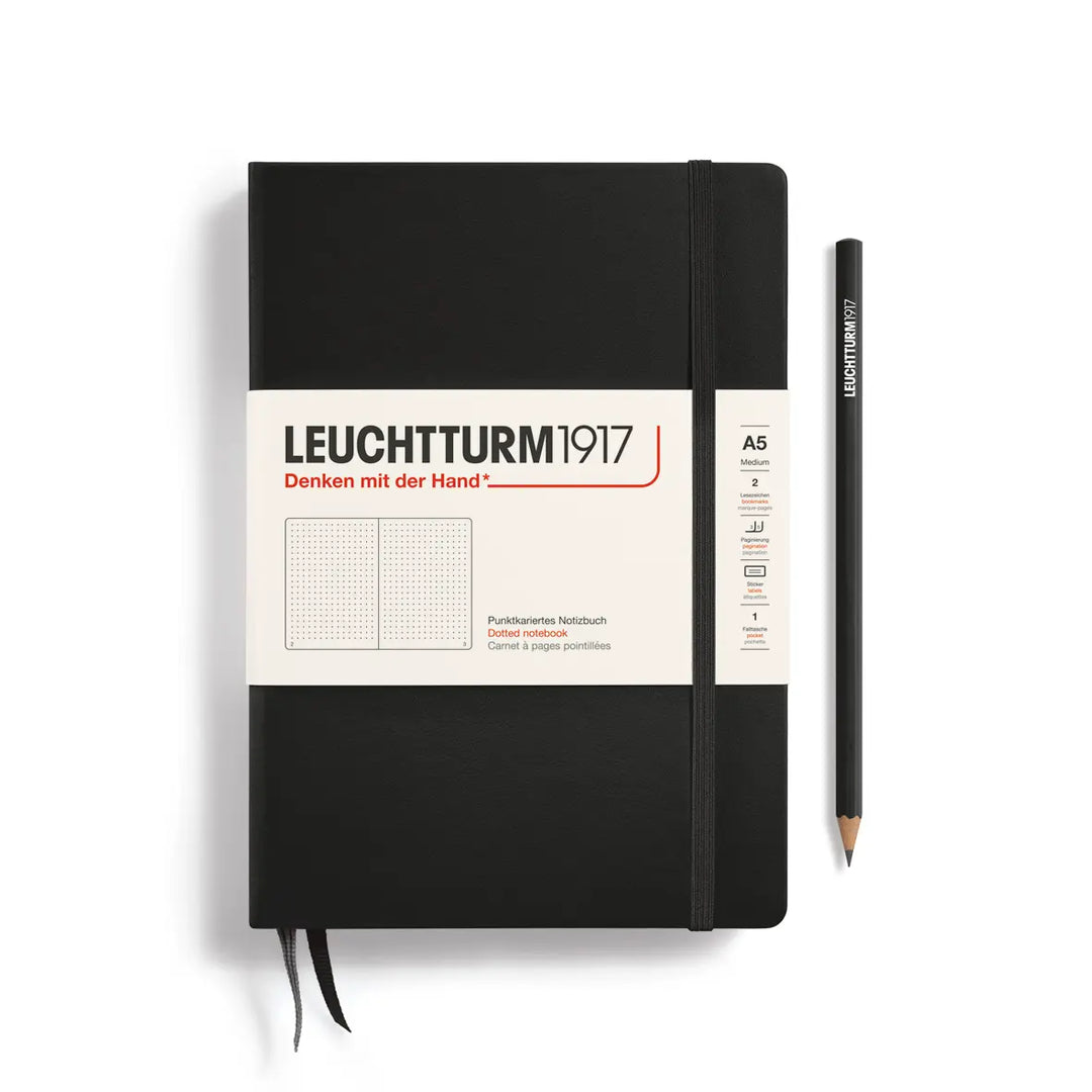 Black notebook with a pencil on a white background, featuring Leuchtturm1917 branding.
