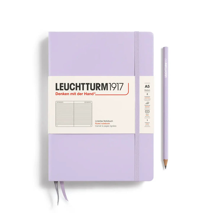 Purple notebook with a pencil on a white background, featuring the Leuchtturm1917 brand.