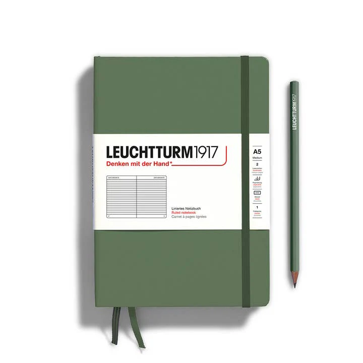 Green notebook with white label and pencil on a white background, featuring Leuchtturm1917 branding.