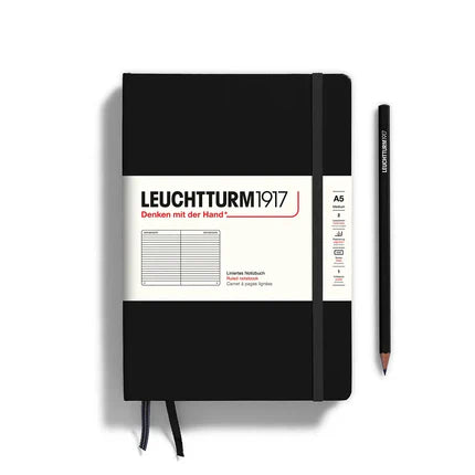 Black notebook with a pencil on a white background, featuring Leuchtturm1917 branding.