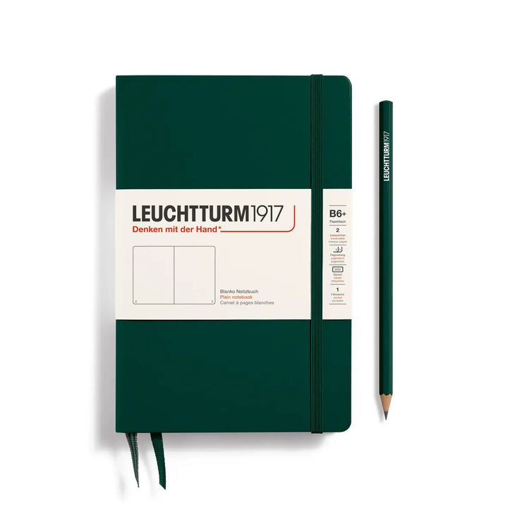 Green notebook with a pencil on a white background, featuring the Leuchtturm1917 brand.