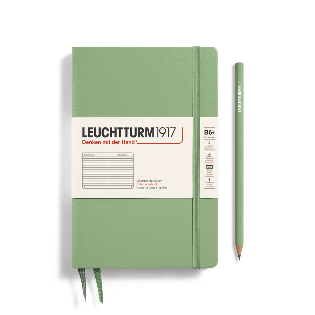 Green notebook with Leuchtturm1917 branding and a pencil on a white background