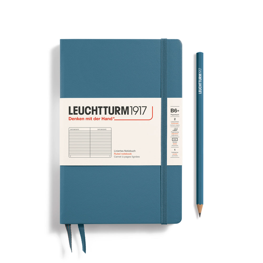 Blue notebook with white label and pencil on a white background, featuring Leuchtturm1917 branding.