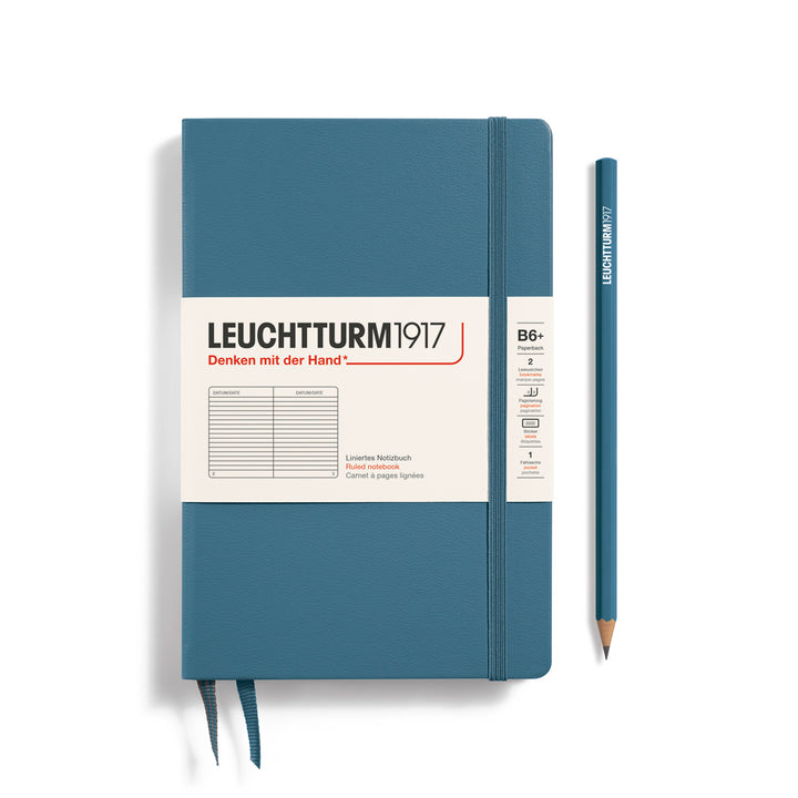Blue notebook with white label and pencil on a white background, featuring Leuchtturm1917 branding.