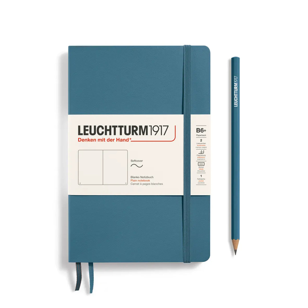 Blue notebook with a pencil on a white background, featuring the Leuchtturm1917 brand.