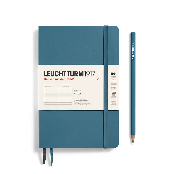 Blue notebook with a pencil on a white background, featuring the Leuchtturm1917 brand.